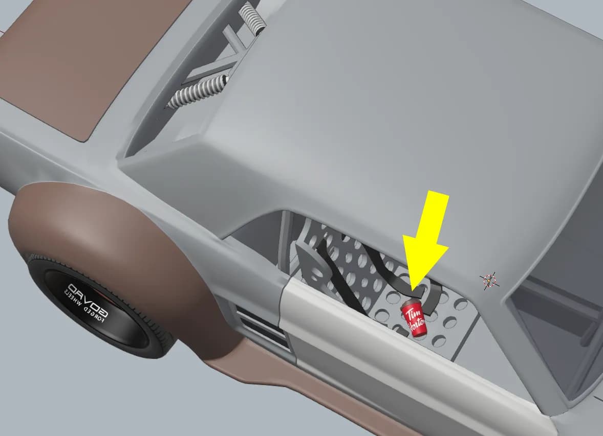 The same coffee cup modelled into the Mustang's interior, marked with an arrow
