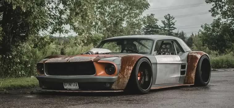The owner's photo of the widebody Mustang in profile on an open road