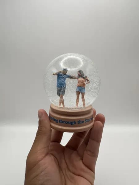 A custom snow globe with 3D printed figures of a dancing couple