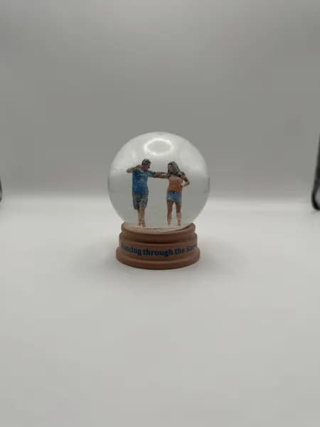 A custom 3D printed snow globe containing a dancing couple