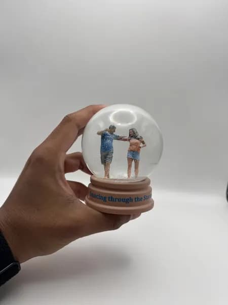 A custom 3D printed snow globe containing a dancing couple