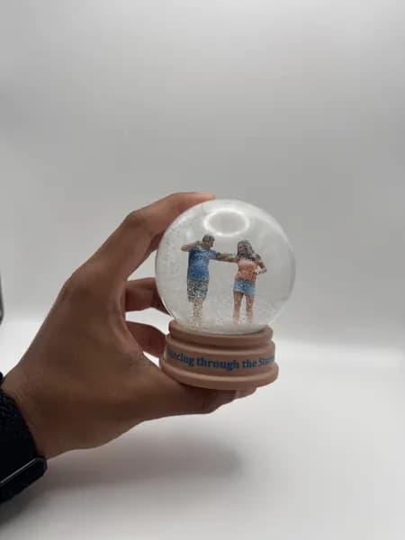 A custom 3D printed snow globe containing a dancing couple