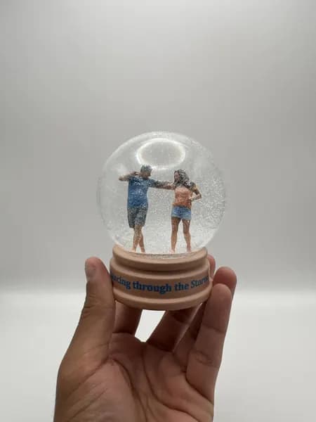A custom 3D printed snow globe containing a dancing couple