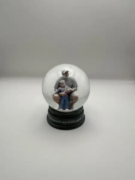 A custom 3D printed snow globe containing a father and daughter