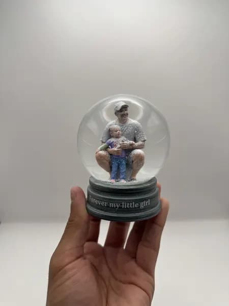 A custom 3D printed snow globe containing a father and daughter
