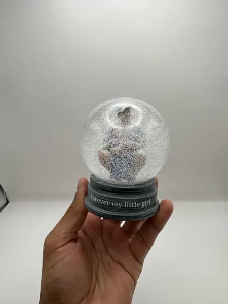 A custom 3D printed snow globe containing a father and daughter