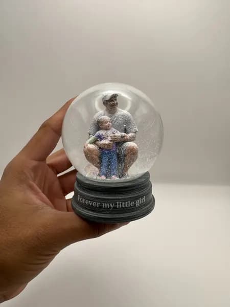 A custom 3D printed snow globe containing a father and daughter