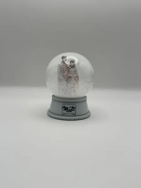 A custom 3D printed snow globe containing a couple in full Indian wedding dress