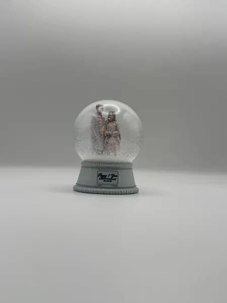 A custom 3D printed snow globe containing a couple in full Indian wedding dress
