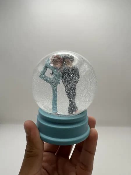 A custom 3D printed snow globe containing a stylised manga couple