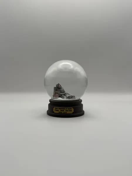 A custom 3D printed snow globe containing a sculpted night-time scene