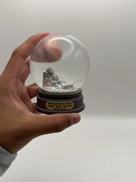 A custom 3D printed snow globe containing a sculpted night-time scene