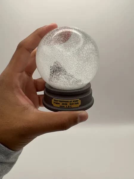 A custom 3D printed snow globe containing a sculpted night-time scene