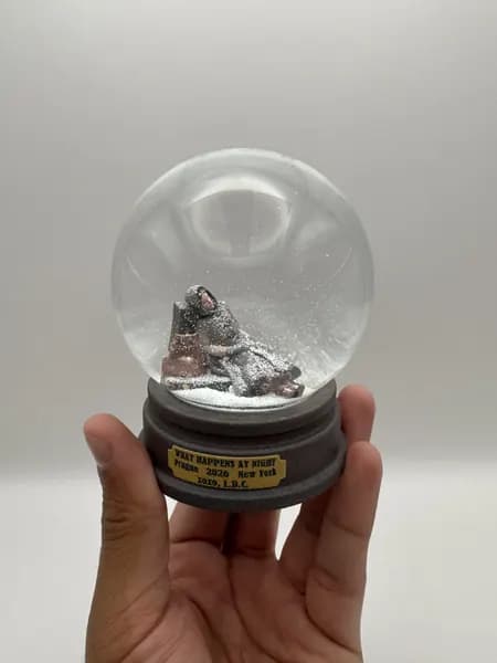 A custom 3D printed snow globe containing a sculpted night-time scene
